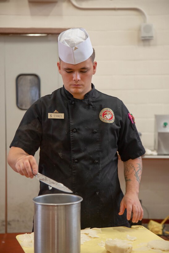 U.S. Marine Corps Lance Cpl. Christophe Caskey, a food service specialist with Headquarters Battalion, Marine Corps Base Hawaii, prepares food for the Chef of the Year Cook-off at Anderson Chow Hall, MCBH, Jan. 27, 2023. The competition consisted of each Chef of the Quarter winner or runner-up competing against each other in a cook-off and series of evaluations including a written test, display/presentation and creativity, Lance Cpl. Anarosa Crosdale, the winner of the competition received a Navy and Marine Corps Achievement Medal. (U.S. Marine Corps photo by Lance Cpl. Clayton Baker)