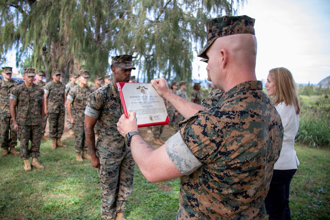 U.S. Marine Corps Sgt. Maj. Joseph Caputo, Marine Corps Base Hawaii Sgt. Maj., reads a Navy and Marine Corps Achievement Medal award citation during a recognition ceremony, MCBH, Jan. 27, 2022. Cpl. Ormandre Harris, a personnel chief with Marine Corps Air Station Kaneohe Bay, was selected as the 2022 MCBH Noncommissioned Officer of the Year. (U.S. Marine Corps photo by Cpl. Cody Purcell)