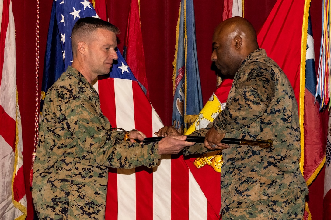U.S. Marine Corps Col. Thomas M. Bedell, the commanding officer of Marine Corps Air Station Miramar presents Sgt. Maj. Marquis L. Young with the noncommissioned officer sword in place of Sgt. Maj. Jason R. Cain, who retired early December Feb. 3, 2023. Young, a native of Memphis, Tennessee, serves as the station sergeant major of MCAS Miramar. Prior to his new position, Young successfully completed his third tour in Marine Corps Recruiting Command. (U.S. Marine Corps photo by Lance Cpl. Jackson Rush)