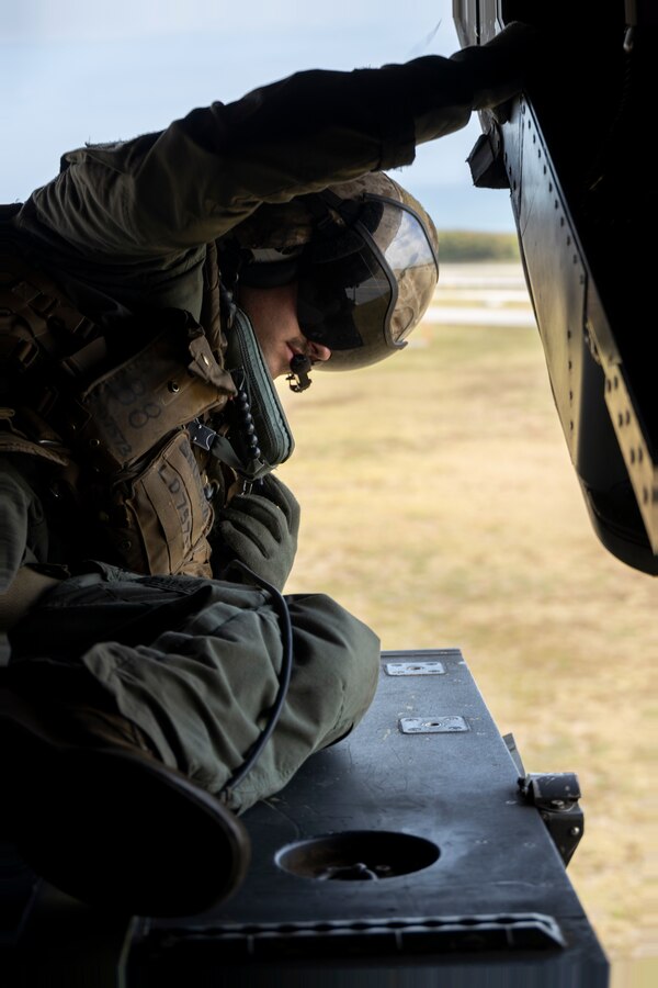 U.S. Marine Corps Lance Cpl. Louis Donatucci III, a crew chief with Marine Medium Tiltrotor Squadron 161, Marine Aircraft Group 16, 3rd Marine Aircraft Wing, surveys the area before landing at Patrick Space Force Base, Florida, Feb. 2, 2023. U.S. Marines and Airmen participated in an alternate insertion and extraction exercise to enhance joint interoperability and techniques for personnel recovery. Donatucci is a Feasterville, Pennsylvania, native. (U.S. Marine Corps photo by Cpl. Daniel Childs)