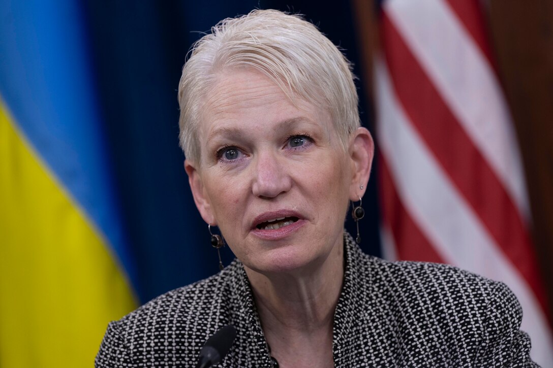 Celeste Wallander, assistant secretary of defense for International Security Affairs is seen close up with an American and Ukraine flag background.