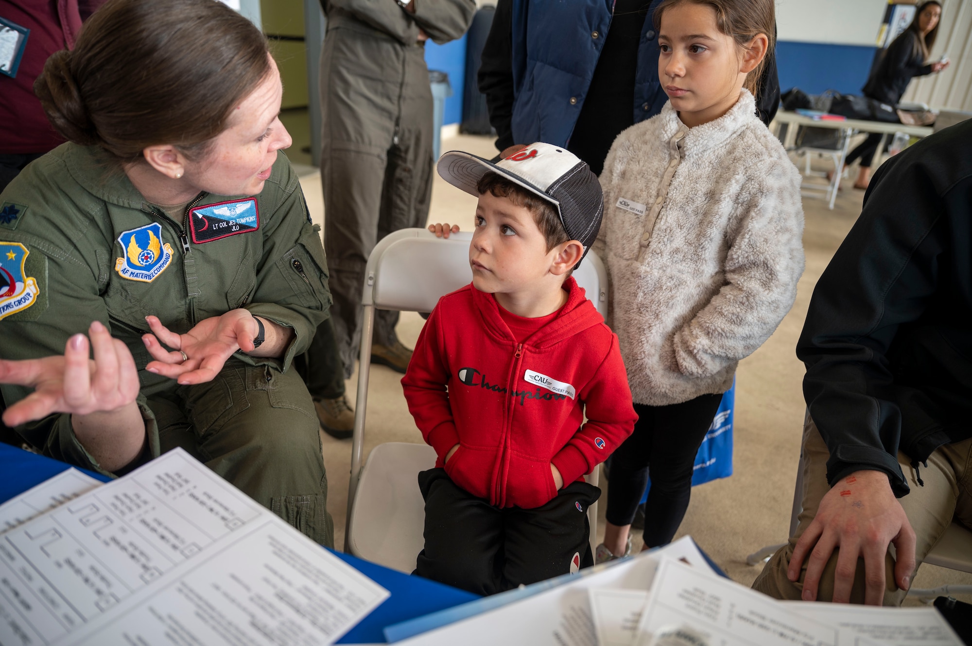 Lt. Col. Jessica Tompkins, Deputy Commander, 412th Operations Group teaches a young boy about how to use the flight simulator at California Aeronautical University Aviation Career Day.