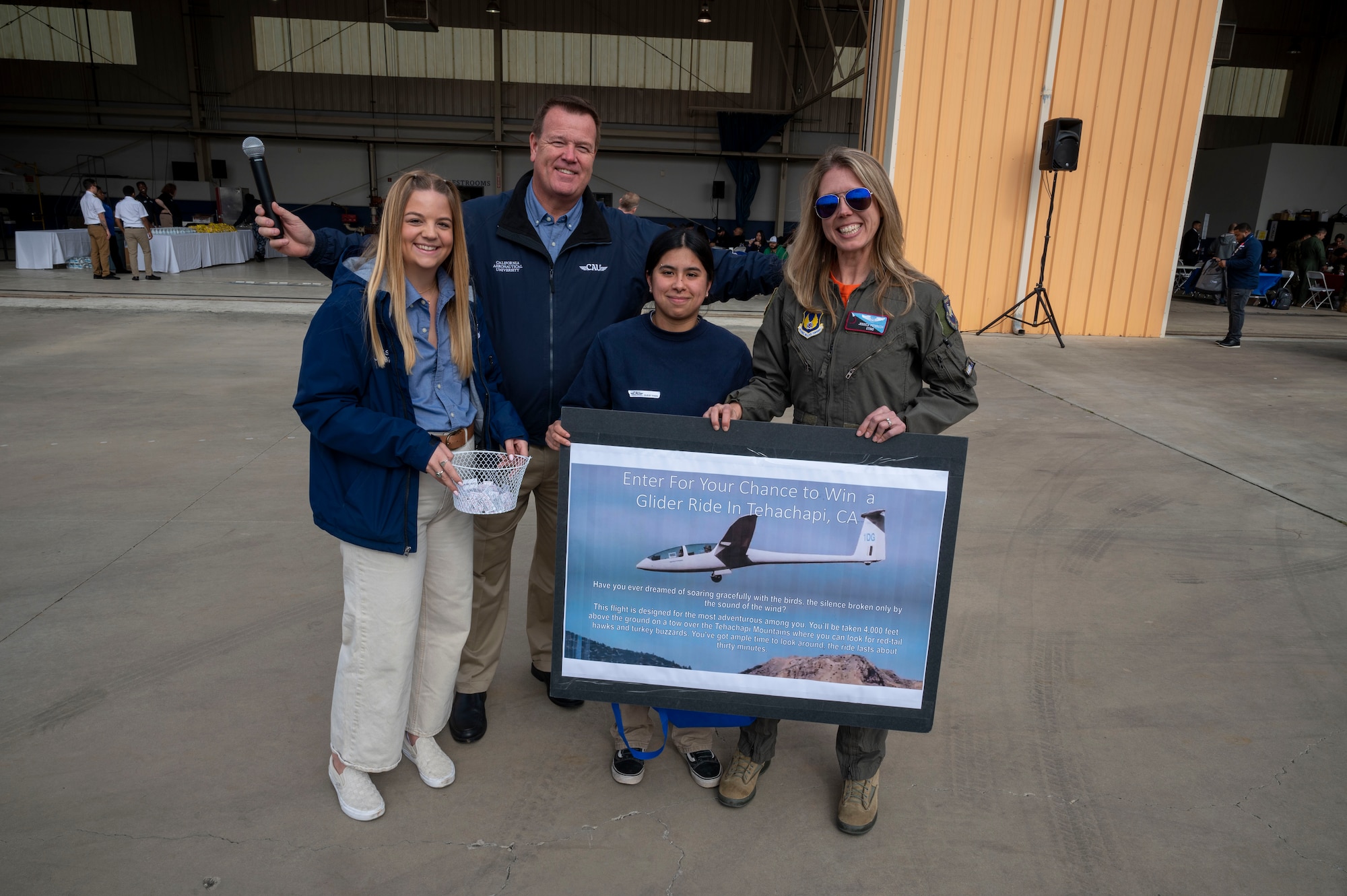 Jessica "Sting" Peterson, Technical Director, 412th Operations Group presents a Tehachapi glider trip prize to a winning student at California Aeronautical University Aviation Career Day in Bakersfield, California, Feb. 3.