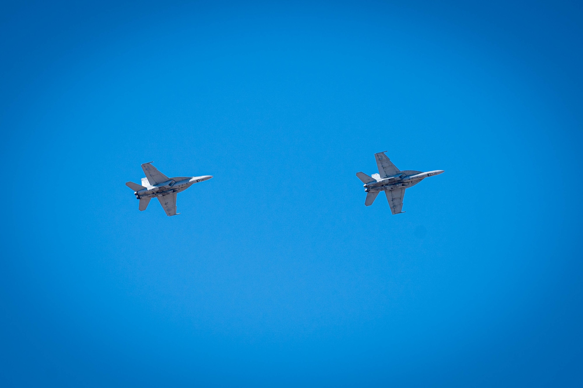 Two U.S. Navy F/A-18F Super Hornets assigned to the “Flying Eagles” Strike Fighter Squadron (VFA) 122 out of Naval Air Station (NAS) Lemoore, California, soar at Luke Air Force Base, Arizona, Feb. 7, 2023.