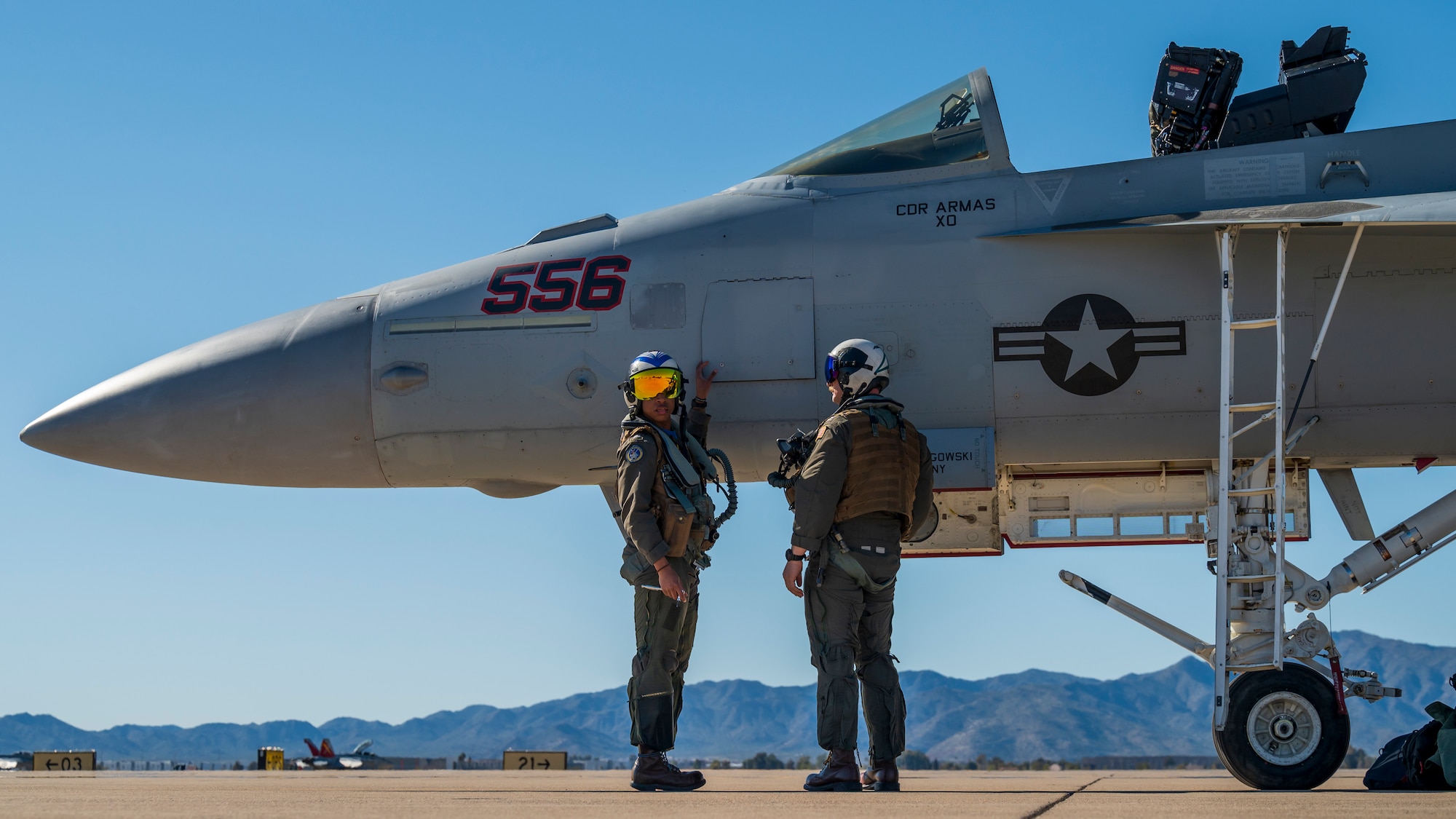 U.S. Navy Lt. Lenue Gilchrist (left), EA-18G Growler aircrew electronic warfare officer, and Lt. Slawomir Glownia (right), EA-18G Growler VAQ 129 pilot, disembark an EA-18G Growler assigned to the “Vikings” of Electronic Attack Squadron (VAQ) 129, Oak Harbor, Washington, at Luke Air Force Base, Arizona, Feb. 7, 2023.