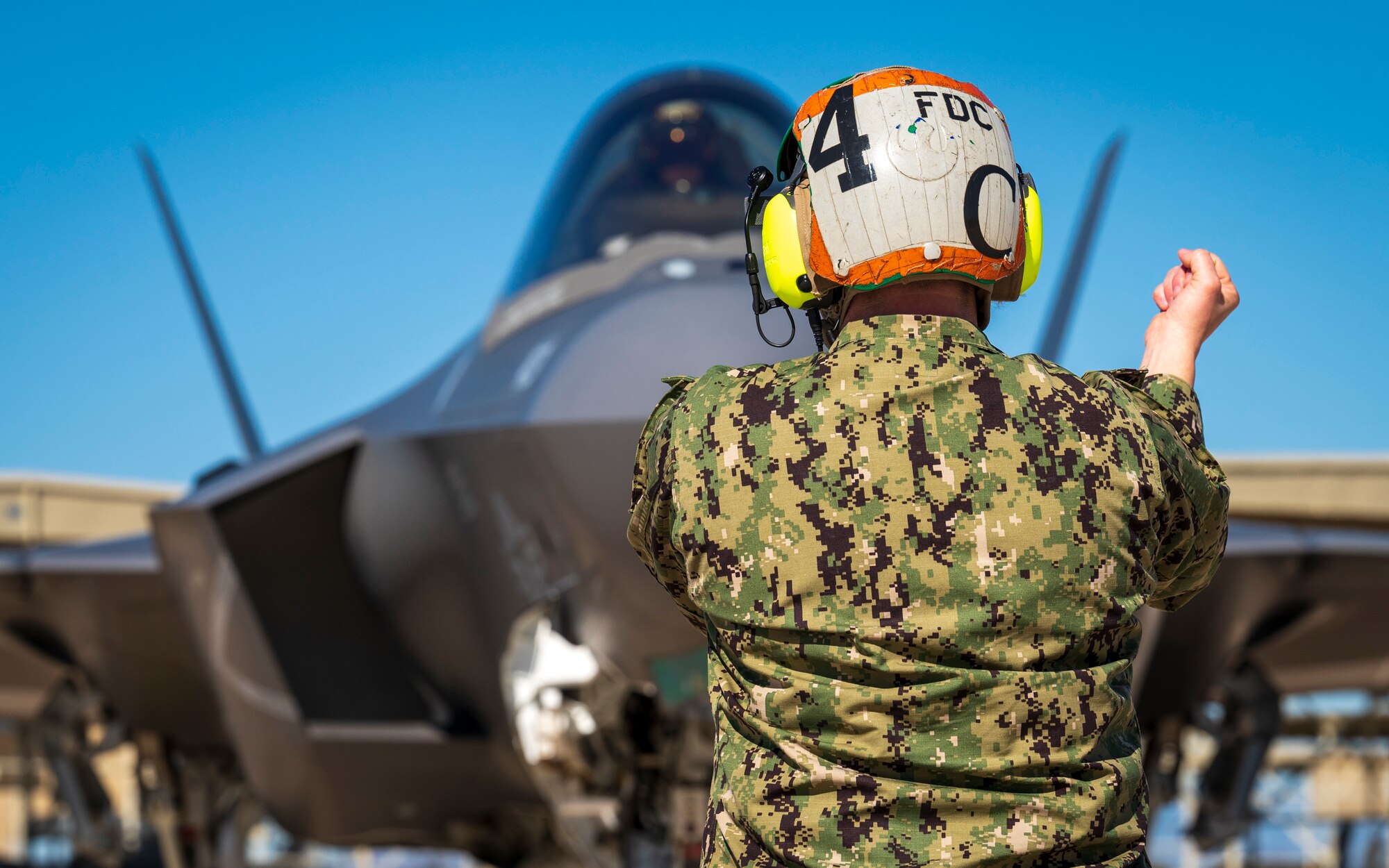 U.S. Navy ADC Tabitha Bledsoe communicates with the pilot of an F-35C Lightning II assigned to the “Warhawks” of Strike Fighter Squadron (VFA) 97, Lemoore, California, at Luke Air Force Base, Arizona, Feb. 7, 2023.