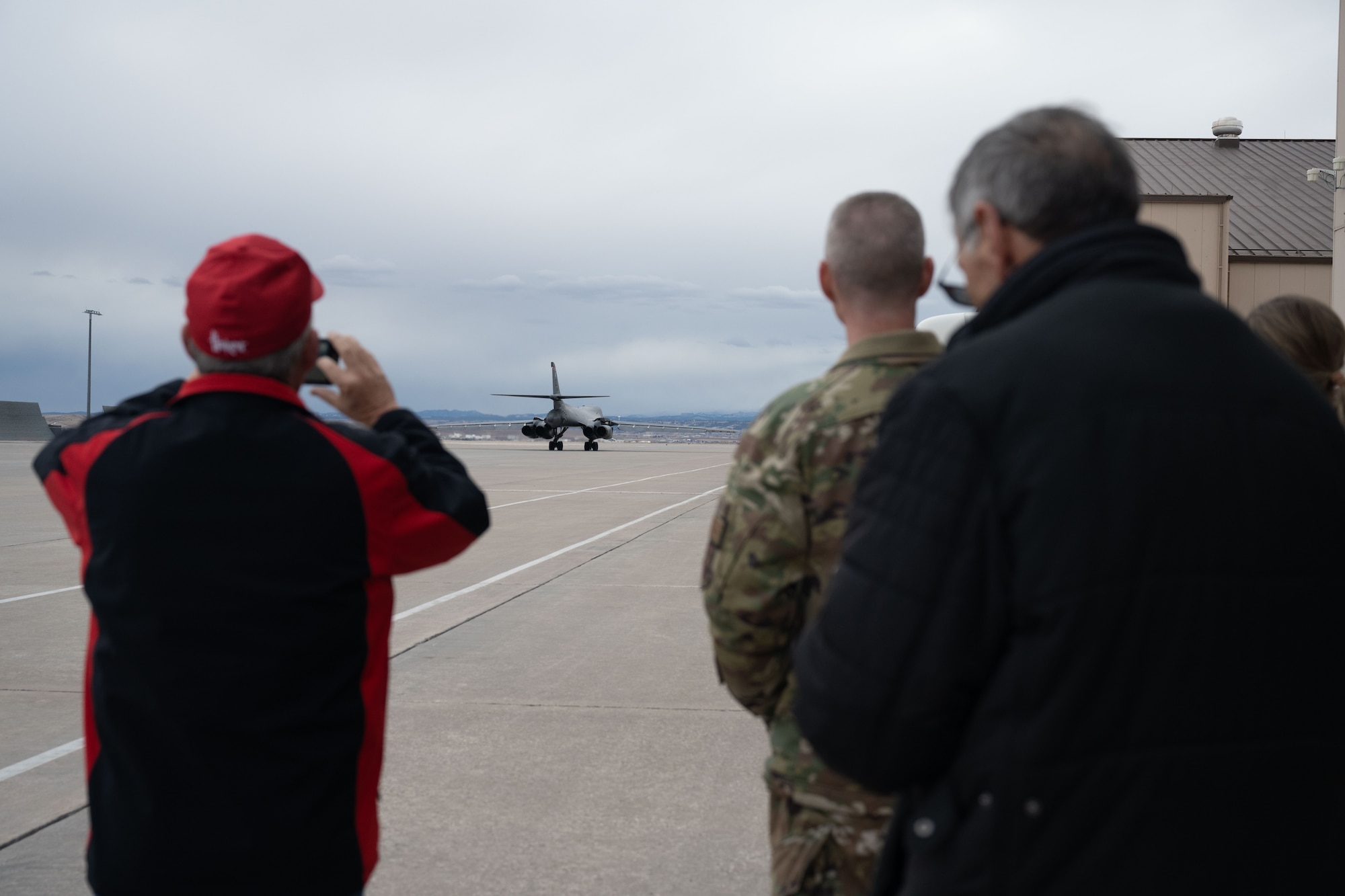 Community and business leaders from the greater Cheyenne area participating in a civic leader tour hosted by the 90th Missile Wing at F.E. Warren Air Force Base, Wyoming, watch as a B-1B Lancer taxis prior to take off as part of the group’s visit to Ellsworth AFB, South Dakota, Feb. 8, 2023.