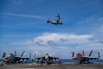 An MV-22 Osprey from the “Ugly Angels” of Marine Medium Tiltrotor Squadron (VMM) 362 flies by the aircraft carrier USS Nimitz (CVN 68). Nimitz Carrier Strike Group (NIMCSG) and Makin Island Amphibious Group (MKI ARG) with embarked 13th Marine Expeditionary Unit (13th MEU) are conducting combined expeditionary strike force (ESF) operations in the South China Sea as part of continuing and routine interoperability training operations in the Indo-Pacific region. Nimitz is in U.S. 7th Fleet conducting routine operations. 7th Fleet is the U.S. Navy's largest forward-deployed numbered fleet, and routinely interacts and operates with Allies and partners in preserving a free and open Indo-Pacific region. (U.S. Navy photo by Mass Communication Specialist 2nd Class Justin McTaggart)