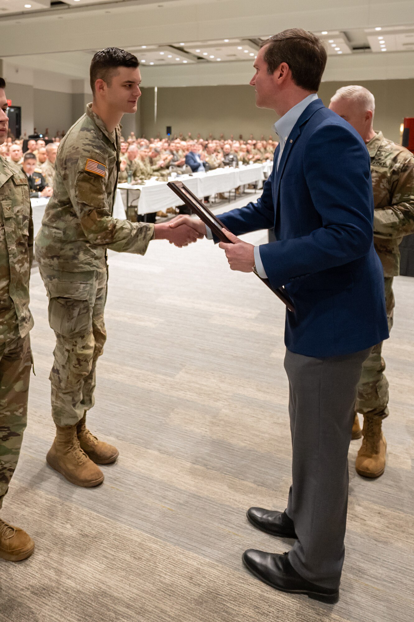 Kentucky Gov. Andy Beshear presents the Kentucky National Guard Outstanding Soldier of the Year award to Spc. Garner Offutt during Leadership Development Day, held at the Kentucky Exposition Center in Louisville, Ky., Feb. 5, 2023. Offutt is assigned to the 138th Field Artillery Brigade. (U.S. Air National Guard photo by Dale Greer)