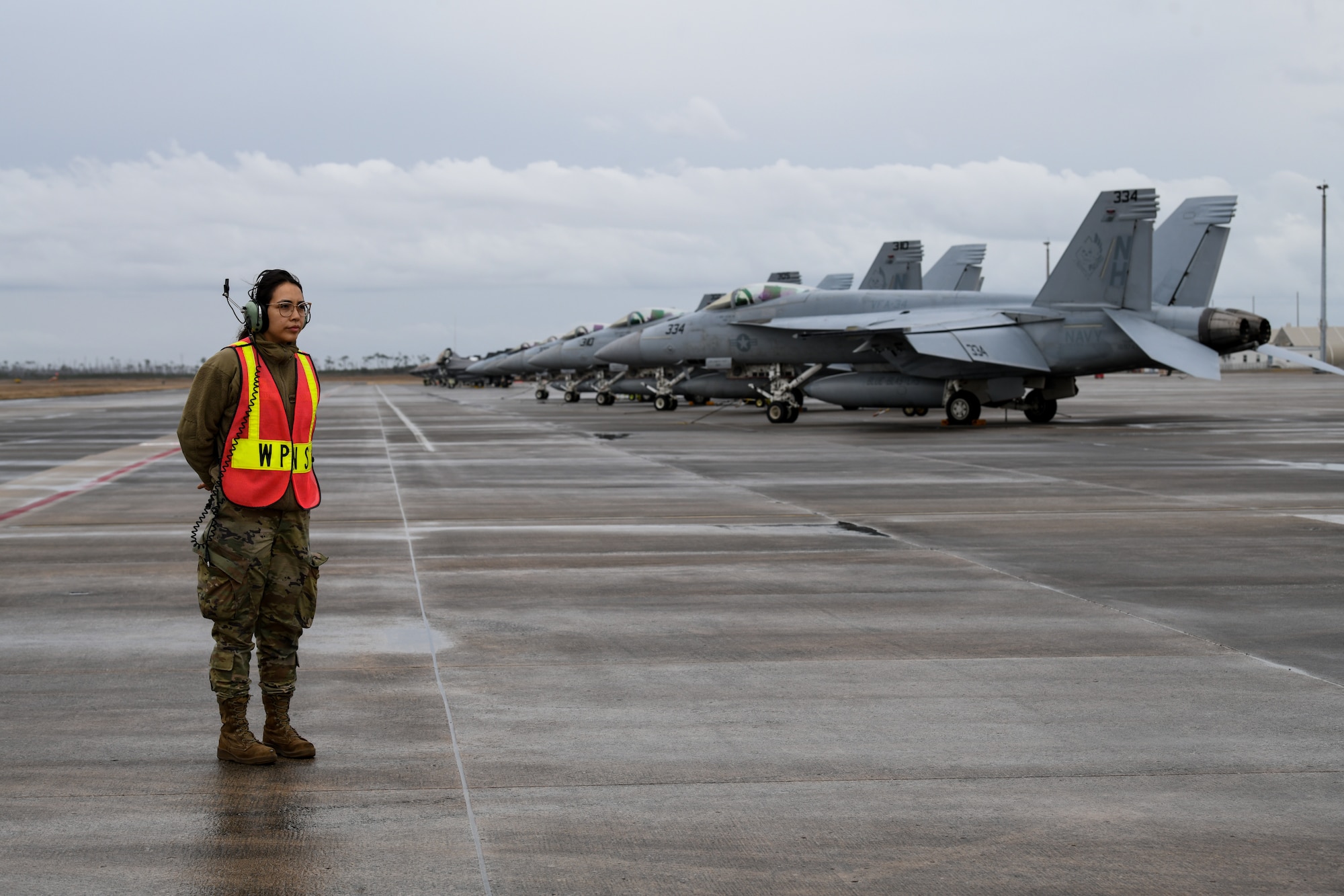 An image of U.S. Air Force Staff Sgt. Maria-Jose Ibarra, load crew chief with the 177th Fighter Wing of the New Jersey Air National Guard, preparing to marshal an F-16C+ Fighting Falcon at Tyndall Air Force Base, Fla.