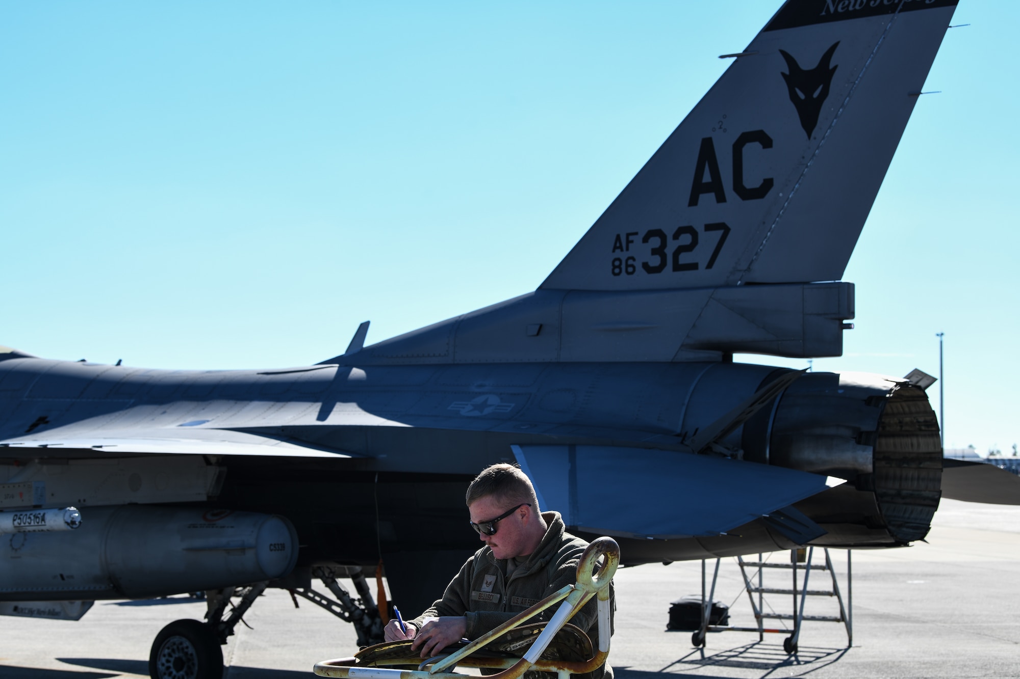 An image of U.S. Air Force Staff Sgt. Mario Bellusci, Jr., crew chief with the 177th Fighter Wing of the New Jersey Air National Guard, updating maintenance documents in between F-16 sorties at Tyndall Air Force Base, Fla.
