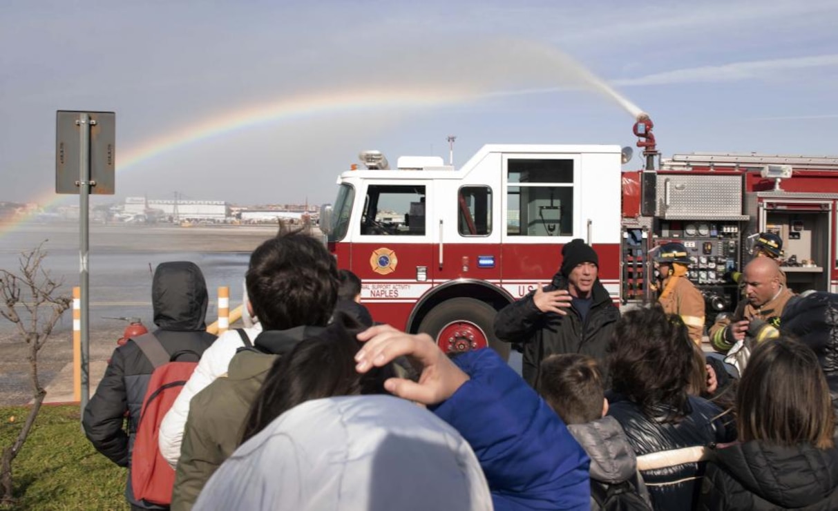 230210-N-IE405-1352 NAVAL SUPPORT ACTIVITY NAPLES, Italy (Feb. 10, 2023) Personnel from U.S. Naval Support Activity (NSA) Naples Fire Department explains a demonstration to local Italian students during a community relations event onboard U.S. Naval Support Activity (NSA) Naples in Capodichino, Italy, Feb. 10, 2023. NSA Naples is an operational ashore base that enables U.S., allied, and partner nation forces to be where they are needed, when they are needed to ensure and stability in the European, African, and Central Command areas of responsibility. (U.S. Navy photo by Mass Communication Specialist)