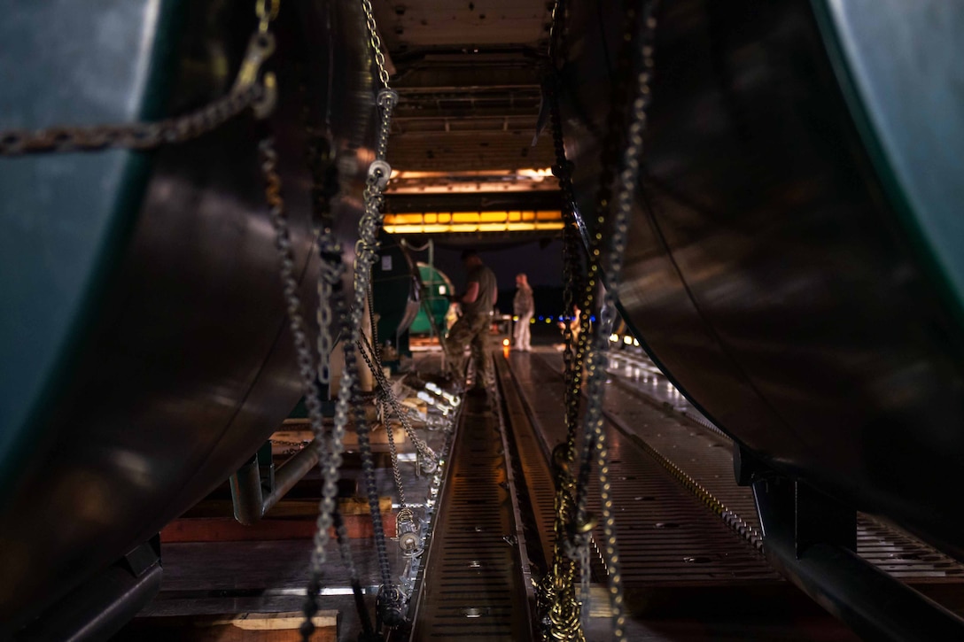 Airmen load equipment onto an aircraft.