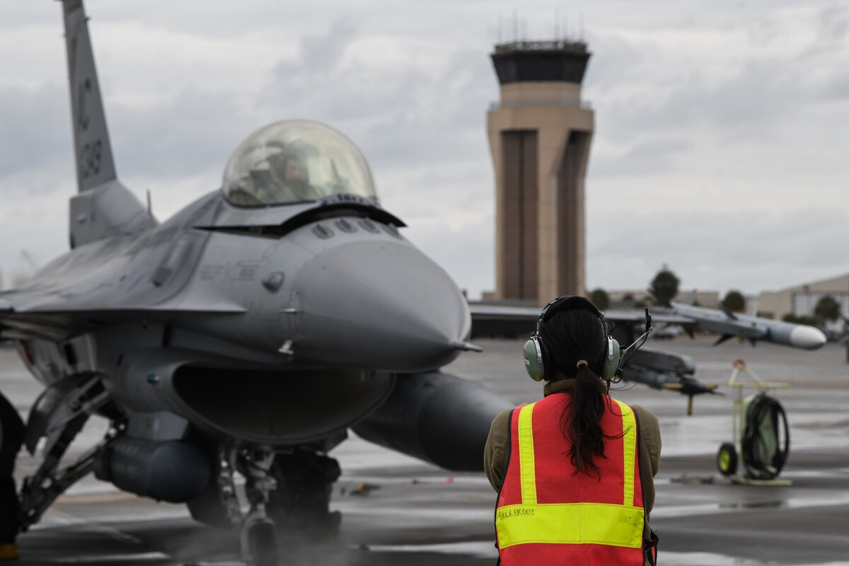 U.S. Air Force Staff Sgt. Maria-Jose Ibarra, load crew chief with the 177th Fighter Wing of the New Jersey Air National Guard, marshals an F-16C+ Fighting Falcon at Tyndall Air Force Base, Fla., Jan. 25, 2023. F-16 pilots, maintainers and support staff from the 177th FW traveled to Tyndall for the Weapons System Evaluation Program.