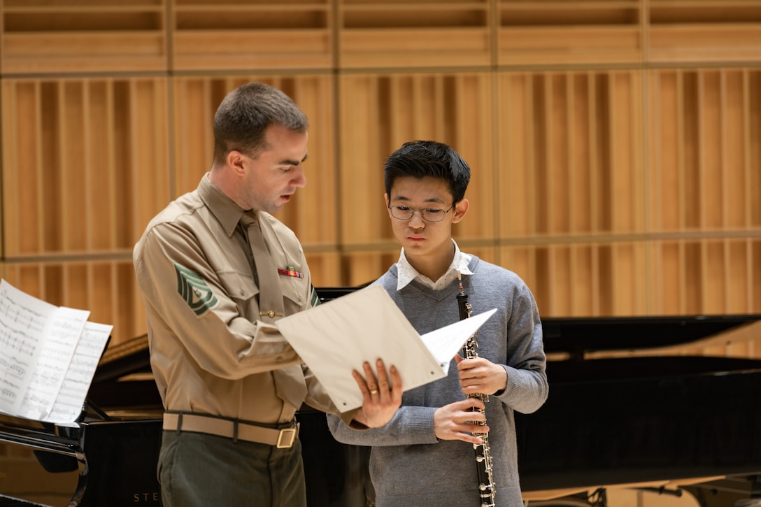 Marine Band musicians work with concerto competition finalists during rehearsal the day before their adjudication. Oboist Gunnery Sgt. Trevor Mowry speaks with Kyle Cho, of Potomac, Md., during the rehearsal.