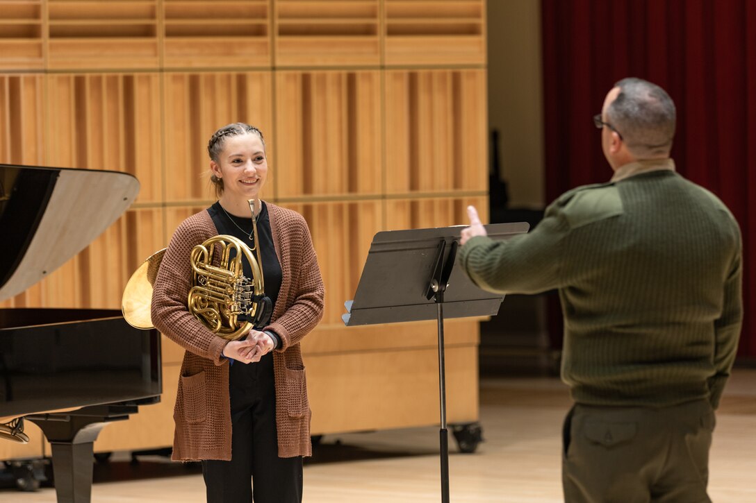 Marine Band musicians work with concerto competition finalists during rehearsal the day before their adjudication. French Horn Player Master Sgt. Douglas Quinzi speaks with Julianna Hollenbach, of American Fork, Utah, during the rehearsal.