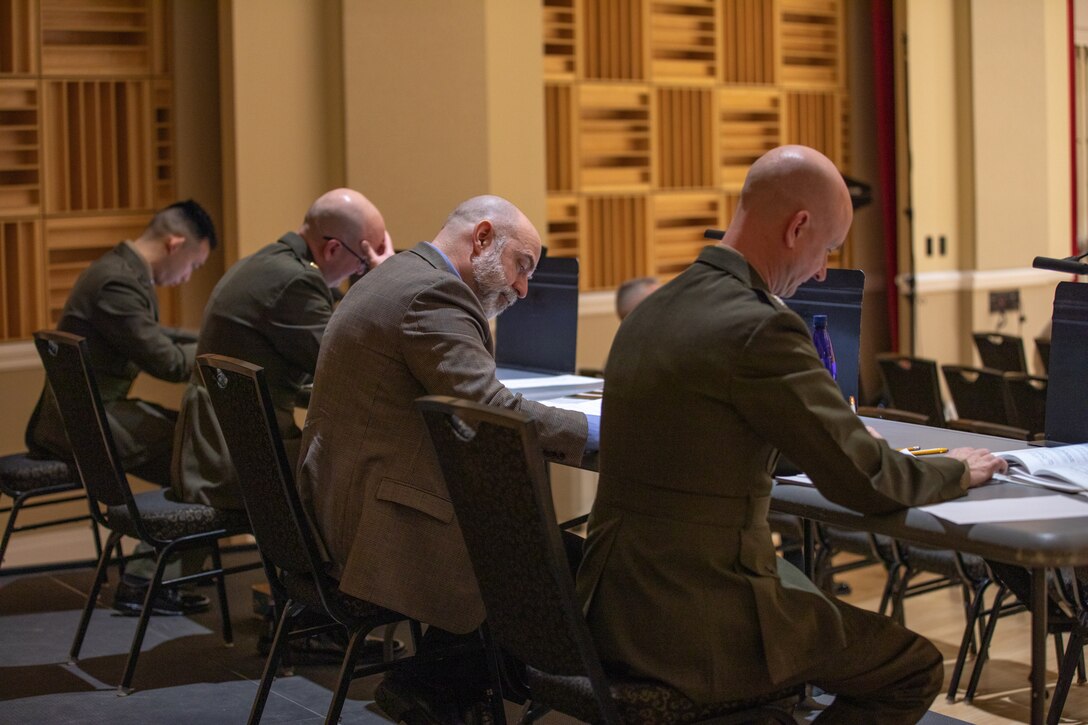 Judges 1st Lt. Darren Lin, Maj. Ryan Nowlin, Dr. Timothy Robblee, and Col. Jason Fettig evaluate a performance by a concerto competition finalist.