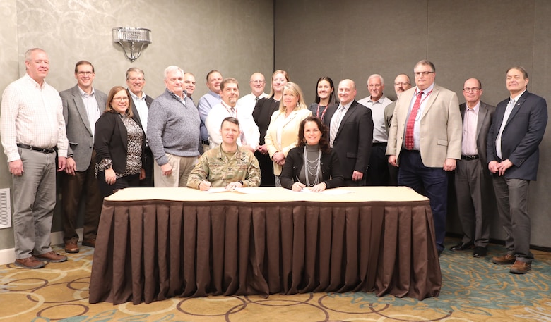 Members of the Brandon Road Interbasin Project Governance Team gather with USACE Rock Island District Commander, Col. Jesse Curry, and Illinois Department of Natural Resources Director, Natalie Phelps Finnie, as they sign the design agreement amendment to accept accelerated funding.