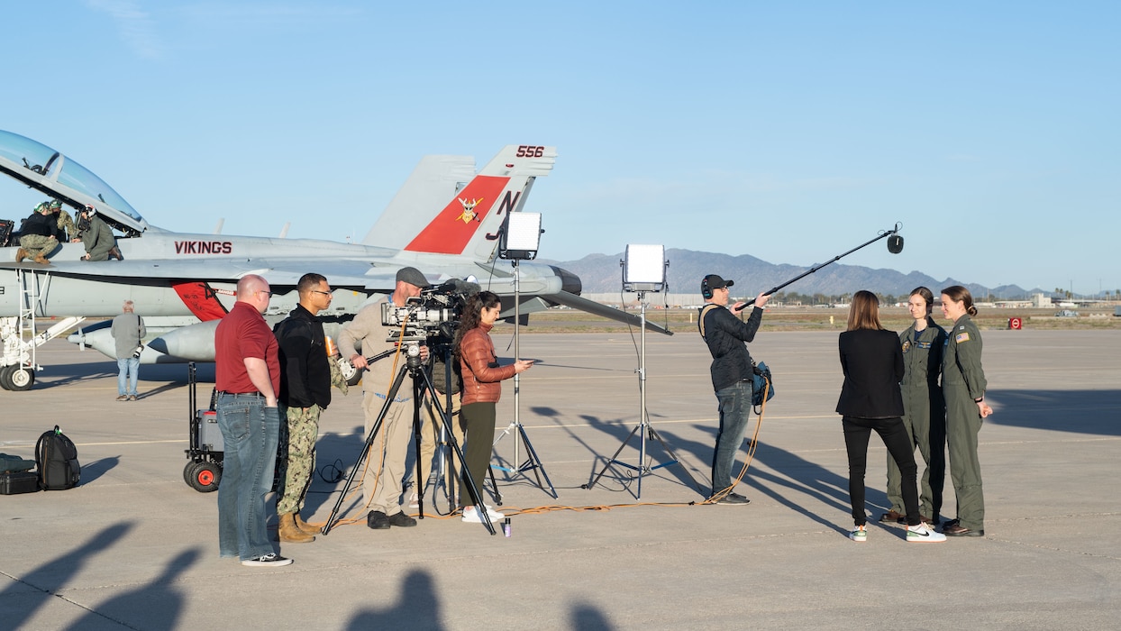Lt. Caitie Perkowski, assigned to Strike Fighter Squadron (VFA) 192, and Lt. Suzelle Thomas, assigned to VFA-97, speak to local media at Luke Air Force Base, Arizona, Feb. 7, 2023, in preparation for their flyover of Super Bowl LVII at State Farm Stadium in Glendale on Feb. 12, 2023.