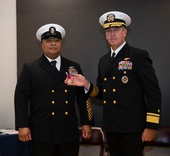 NEWPORT, R.I. (Feb. 2, 2023) Rear Adm. Pete Garvin, commander, Naval Education and Training Command, right, awards Command Master Chief Baron Randle, director, U.S. Navy Senior Enlisted Academy (SEA), the Legion of Merit during the SEA change of charge ceremony, Feb. 2, 2023. Command Master Chief David Martinez relieved Randle as the SEA director. The SEA provides senior enlisted leaders with education and training in communication skills, leadership and management, national security affairs, Navy programs and physical fitness. (U.S. Navy photo by Mass Communication Specialist 2nd Class Derien C. Luce)