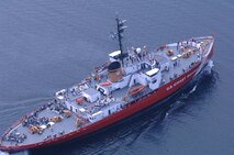 Aerial photo of USCGC Mackinaw in modern red paint scheme showing the icebreaker’s extreme width. (U.S. Coast Guard)