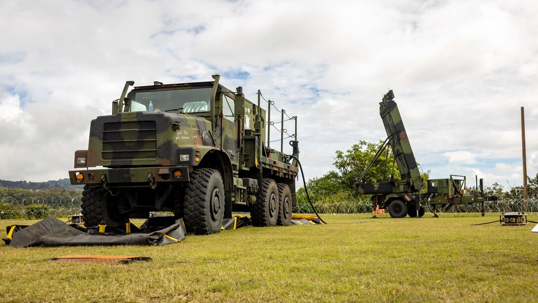 A Medium Tactical Vehicle Replacement and a Ground and Air Task Oriented Radar system are displayed on the site of an expeditionary command and control node during a training exercise at Camp H.M. Smith, Hawaii, Feb. 7, 2023. Forces from I Marine Expeditionary Force and III MEF established a Multi-Function Air Operations Center and Multi-Domain Operations Center during the exercise to synchronize all-domain effects across the Indo-Pacific region for the Joint Force and interagency partners. The C2 node, operated by Marines of MACG-38 and 3rd MAW informed and enabled the synchronization of organic, joint, and/or interagency fires – both lethal and non-lethal – across air, sea, land, space, and cyber to achieve specific, desired effects during the exercise.