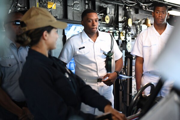 Members of the Royal Bahamian Defense Force Enlisted Corps speak with a Sailor on the bridge of the Arleigh Burke-class guided-missile destroyer USS Gravely (DDG 107) during a port visit to Nassau, Bahamas.