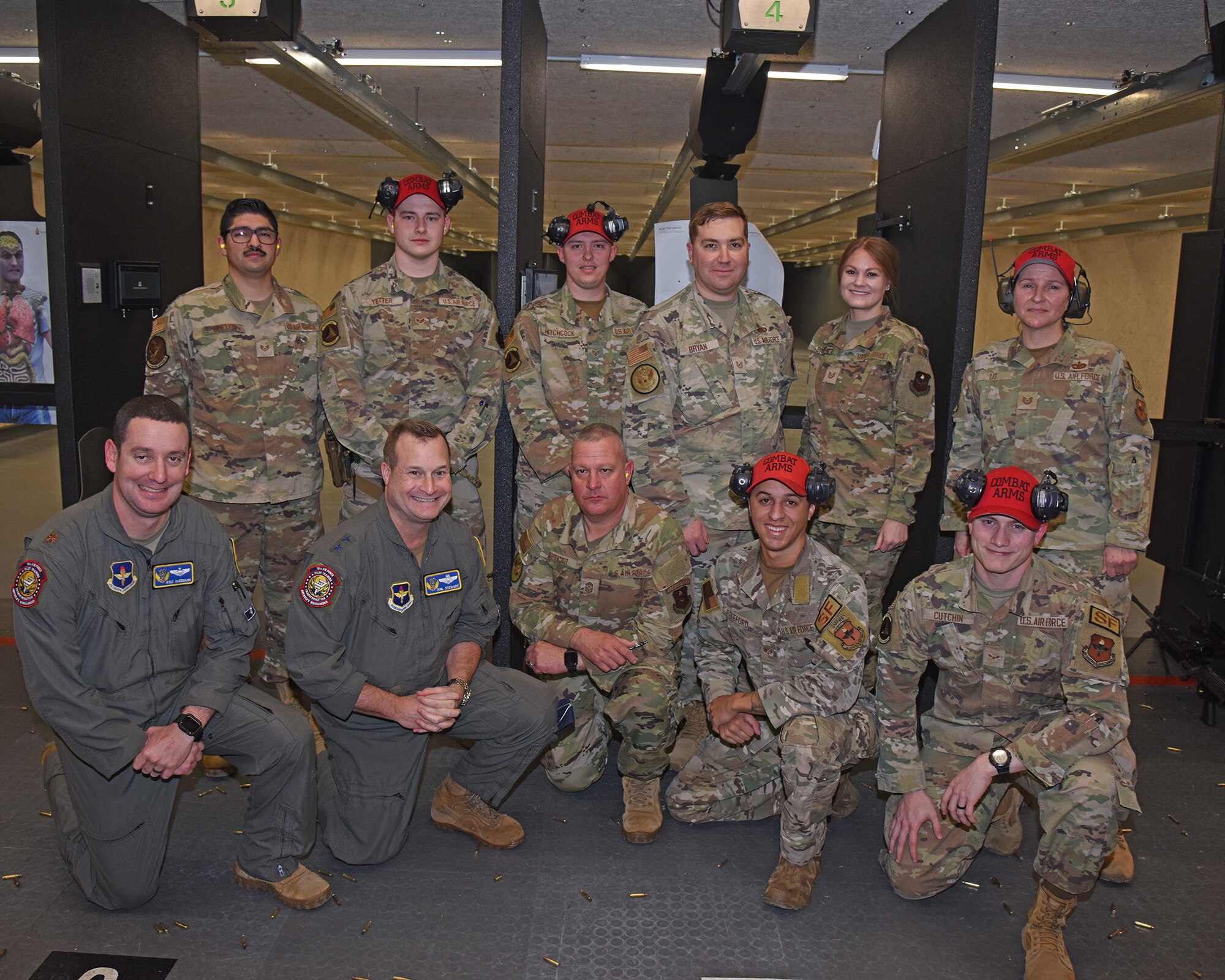 U.S. Air Force Maj. Gen. Phillip Stewart, 19th Air Force commander, and Chief Master Sgt. Justin Apticar, 19th AF command chief, pose with members of the 14th Security Forces Squadron, combat arms division, at Columbus Air Force Base, Mississippi, Feb. 8, 2023.  During their visit, Stewart and Apticar were able to fire several weapons on the new modular indoor firing range at Columbus AFB. The range is the first of its kind in all of Air Education and Training Command. (U.S. Air Force Photo by Elizabeth Owens)