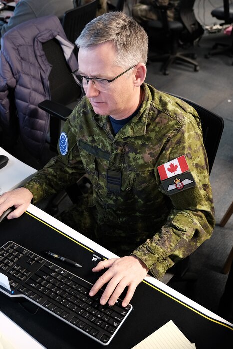 photo of Canadian Air Force military officer working on computer