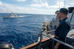 Navy Cmdr. Jake Ferrari, commanding officer of the Arleigh Burke-class guided-missile destroyer USS Paul Hamilton (DDG 60), renders honors to the Indian Navy Sukanya-class patrol craft INS Savitri (P53) during an exercise in the Indian Ocean. Paul Hamilton, part of the Nimitz Carrier Strike Group, is in U.S. 7th Fleet conducting routine operations. 7th Fleet is the U.S. Navy’s largest forward-deployed numbered fleet, and routinely interacts and operates with Allies and partners in preserving a free and open Indo-Pacific region.