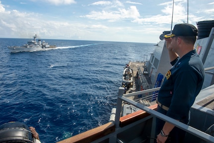 Navy Cmdr. Jake Ferrari, commanding officer of the Arleigh Burke-class guided-missile destroyer USS Paul Hamilton (DDG 60), renders honors to the Indian Navy Sukanya-class patrol craft INS Savitri (P53) during an exercise in the Indian Ocean. Paul Hamilton, part of the Nimitz Carrier Strike Group, is in U.S. 7th Fleet conducting routine operations. 7th Fleet is the U.S. Navy’s largest forward-deployed numbered fleet, and routinely interacts and operates with Allies and partners in preserving a free and open Indo-Pacific region.