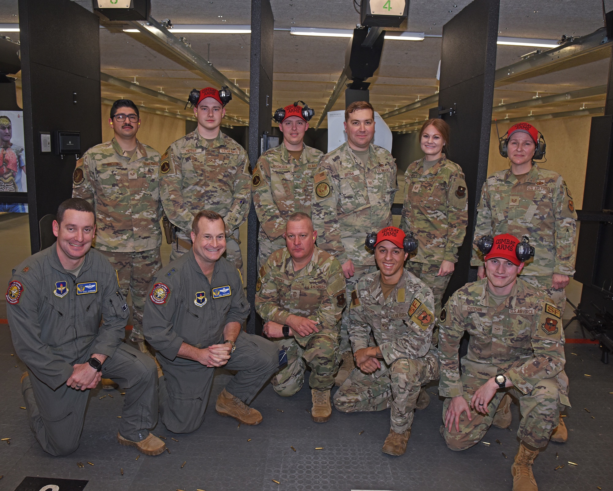 U.S. Air Force Maj. Gen. Phillip Stewart, 19th Air Force commander, and Chief Master Sgt. Justin Apticar, 19th AF command chief, pose with members of the 14th Security Forces Squadron, combat arms division, at Columbus Air Force Base, Mississippi, Feb. 8, 2023.  During their visit, Stewart and Apticar were able to fire several weapons on the new modular indoor firing range at Columbus AFB. The range is the first of its kind in all of Air Education and Training Command. (U.S. Air Force Photo by Elizabeth Owens)