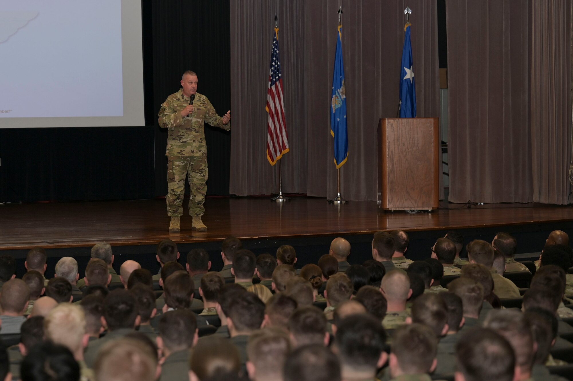 U.S. Air Force Chief Master Sgt. Justin G. Apticar, 19th Air Force command chief, speaks to the Airmen of the 14th Flying Training Wing during a wing All Call, at Columbus Air Force Base, Mississippi, Feb. 7, 2023. (U.S. Air Force photo by Senior Airman Jessica Haynie)