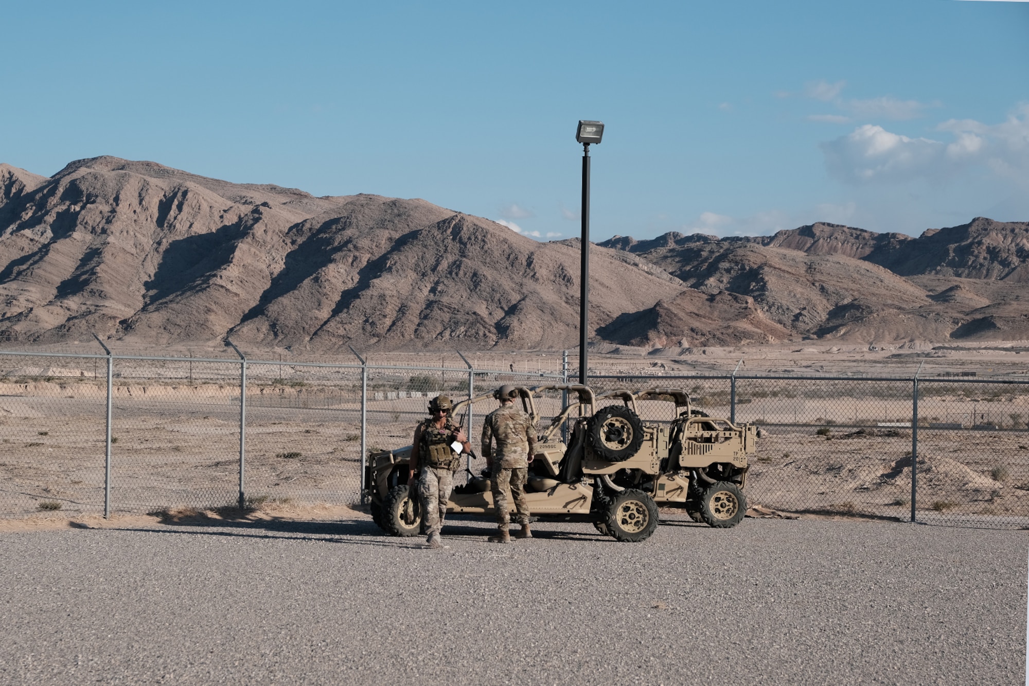 photo U.S. Air Force military members stand near military vehicles