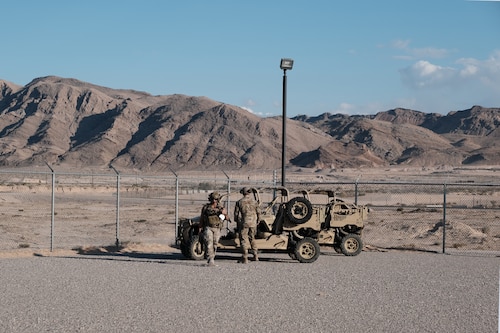 photo U.S. Air Force military members stand near military vehicles