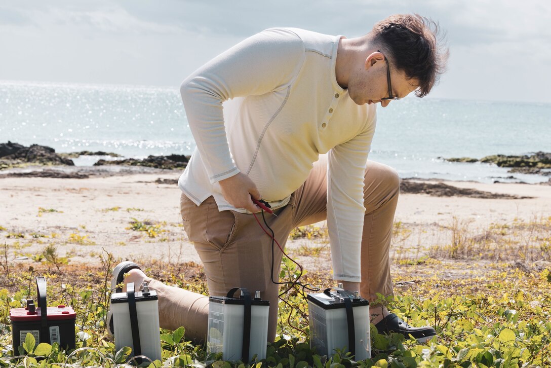 U.S. Marine Corps Sgt. Deven Schools, a fire support Marine with 5th Air Naval Gunfire Liaison Company, III Marine Expeditionary Force Information Group, tests batteries during Innovation Boot Camp on Sea Glass Beach, Okinawa, Japan, Feb. 8, 2023. IBC was designed to teach Marines skills such as soldering, 3D printing, coding, and programming to create innovative products for the Marine Corps and to test Marines’ critical thinking skills. Schools is a native of Kent Island, Maryland. (U.S. Marine Corps photo by Lance Cpl. Tyler Andrews)