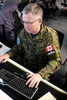 photo of Canadian Air Force military officer working on computer