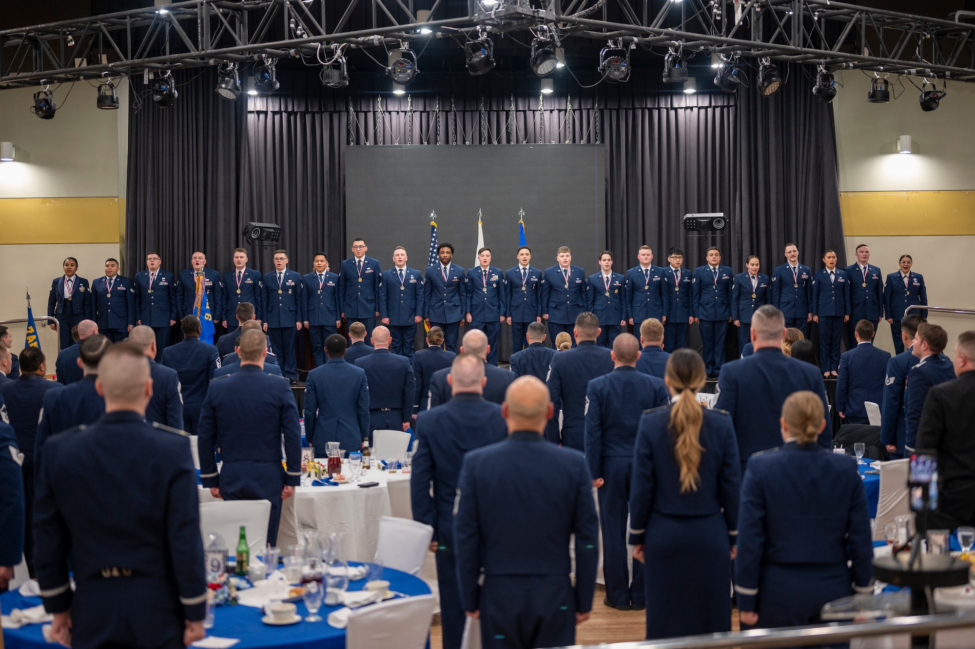 Airman Leadership School Class 23-B sings the official Air Force Song upon graduating at Osan Air Base, Republic of Korea, Feb. 9, 2023. As the first level of professional military education for enlisted Airmen, ALS is designed to be an entry-level course to prepare senior airmen to be in leadership positions. ALS teaches Airmen how to adapt to any management challenges and how to be flexible leaders. (U.S. Air Force Photo by Airman 1st Class Aaron Edwards)