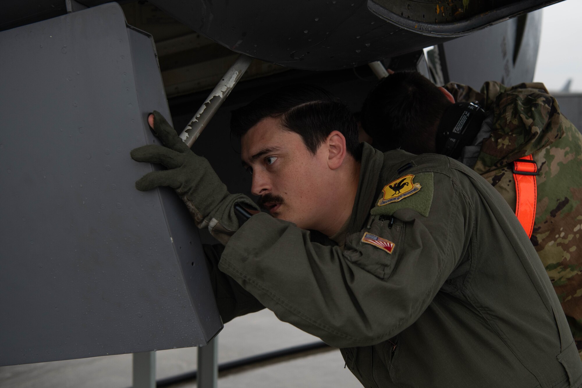 An Airman performs pre-flight checks.