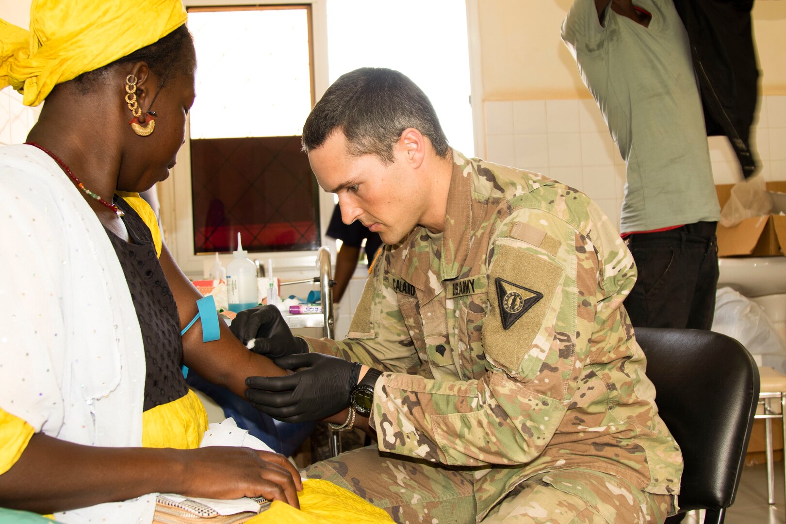 U.S. Army Spc. Joseph Calano, medic, Medical Detachment, Garrison Support Command, Vermont National Guard, draws blood from a patient at the Regional Center Hospital at Tambacounda, Senegal, April 9, 2019. Vermont Guardsmen and their Senegalese counterparts  provide the Department of Defense with cost-effective ways to strengthen alliances and attract new partners.