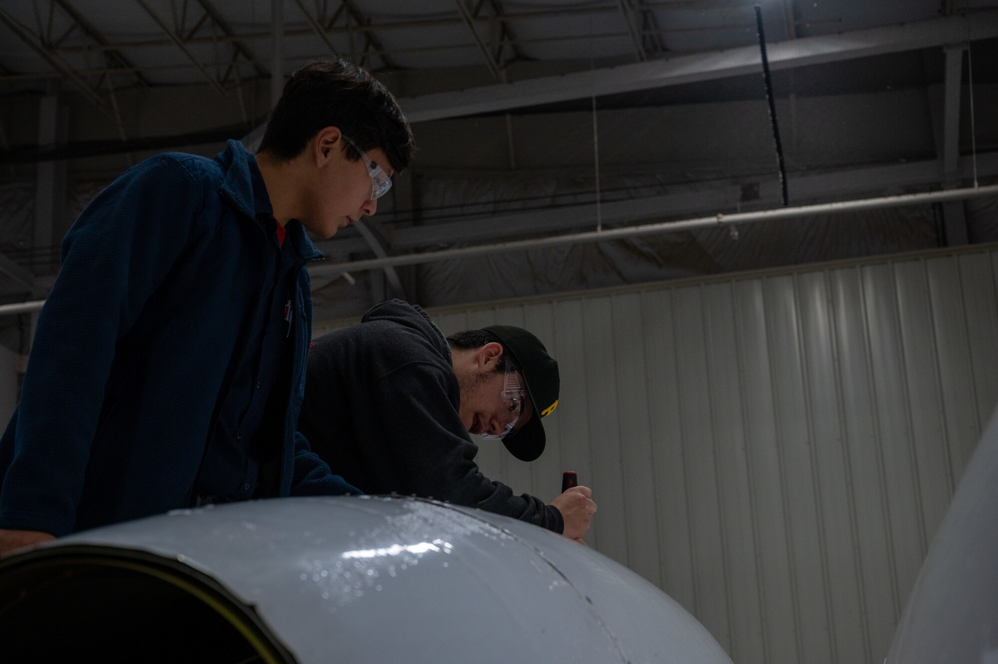 Eric Alvarado (left), and Kody Kenner (right), Del Rio’s Gerardo J. Maldonado Career &amp; Technical Education Program students, practice performing a maintenance inspection on a T-1A Jayhawk on Jan. 30, 2023, at Laughlin Air Force Base, Texas. Senior Students in the program get the most amount of time and opportunity to get hands-on experience working with the aircraft. (U.S. Air Force photo by Senior Airman David Phaff)