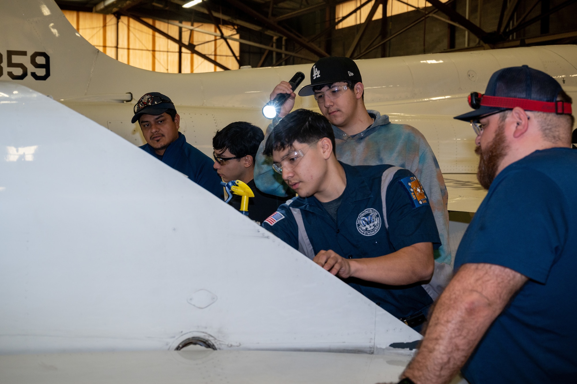 Members of the Laughlin Air Force Base, Texas, maintenance team instruct students on performing routine maintenance on a T-38C Talon on Jan. 30, 2023, at Laughlin Air Force Base, Texas. Senior Students in the program get the most amount of time and opportunity to get hands-on experience working with the aircraft. (U.S. Air Force photo by Senior Airman David Phaff)