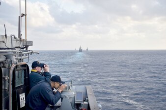 USS Antietam (CG 54) transits the Philippine Sea in a column formation with allied forces during a submarine familiarization exercise.