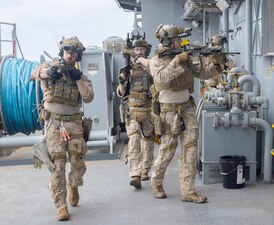 Marines search USS Miguel Keith (ESB 5) during a VBSS exercise off the coast of Okinawa.