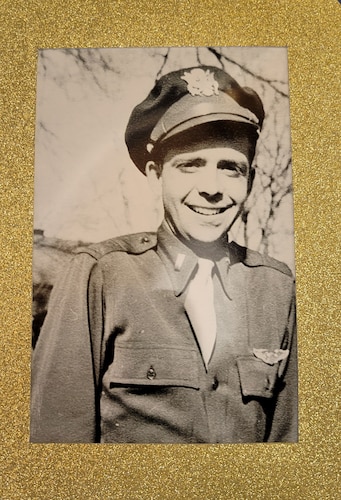 Black and white photo with man in Army uniform from World War II era