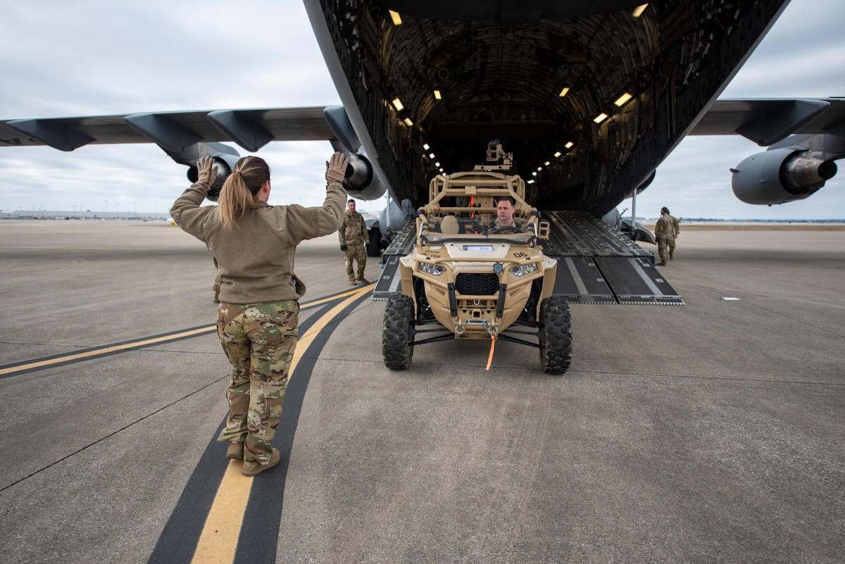 Tech. Sgt. Monica Sealey, a loadmaster with the North Carolina Air National Guard’s 156th Airlift Squadron, directs the loading of a vehicle onto a C-17 Globemaster III at the Kentucky Air National Guard Base in Louisville, Ky., Feb. 10, 2023. The vehicle is being transported to the Northern Mariana Islands for Cope North, a multinational exercise designed to enhance combat readiness in the South Pacific. Fourteen Kentucky Air Guardsmen from the 123rd Contingency Response Group are providing air base-opening and cargo-handling capabilities for Cope North. (U.S. Air National Guard photo by Phil Speck)