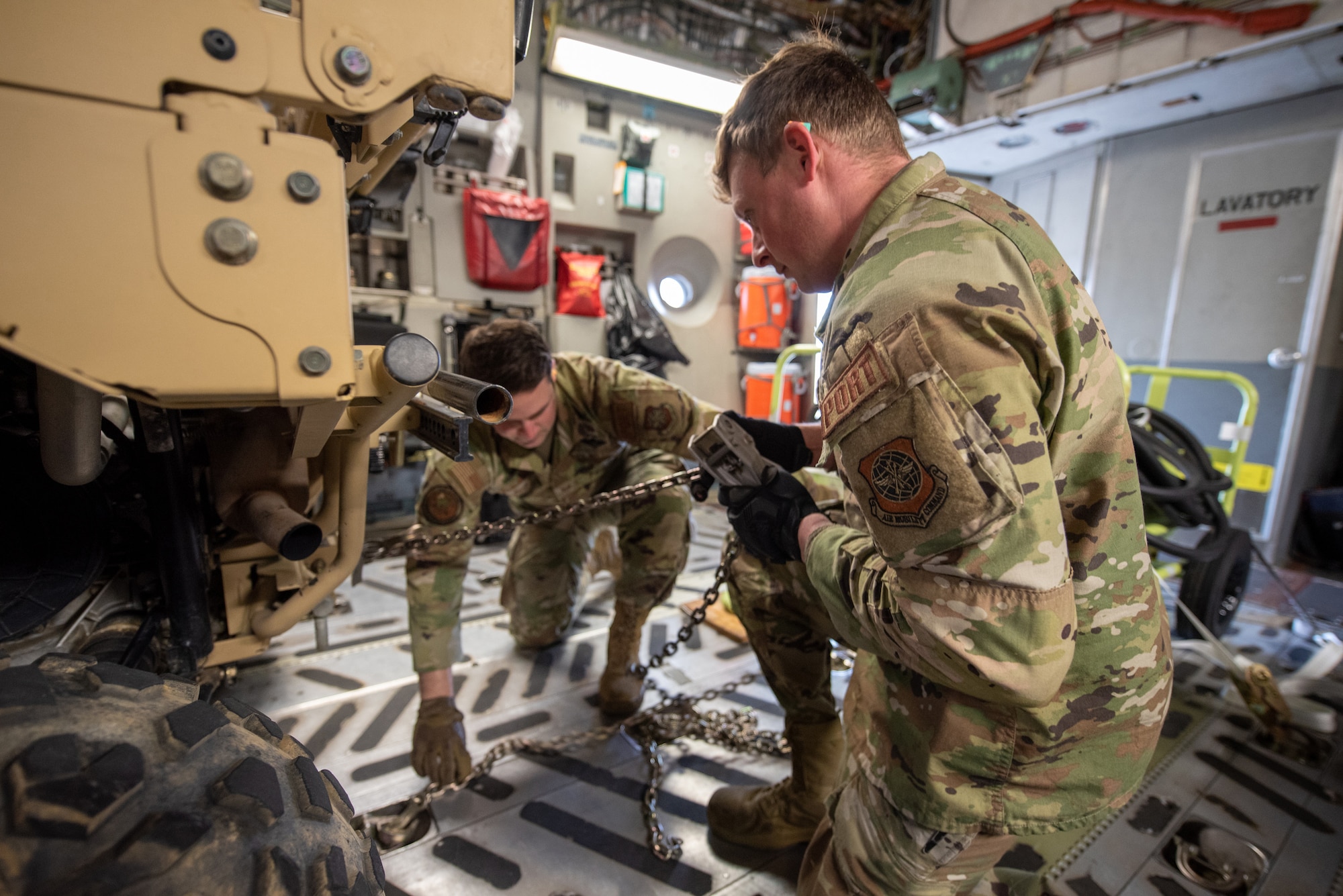 Members of the 123rd Logistics Readiness Squadron secure a vehicle on a North Carolina Air National Guard C-17 Globemaster III at the Kentucky Air National Guard Base in Louisville, Ky., Feb. 10, 2023. The vehicle is being transported to the Northern Mariana Islands for Cope North, a multinational exercise designed to enhance combat readiness in the South Pacific. Fourteen Kentucky Air Guardsmen from the 123rd Contingency Response Group are providing air base-opening and cargo-handling capabilities for Cope North. (U.S. Air National Guard photo by Phil Speck)