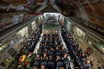 Urban search and rescue members from Fairfax County, Virginia, on a C-17 Globemaster III on Dover Air Force Base, Delaware, Feb. 7, 2023, en route to Türkiye to assist with earthquake relief. The U.S. Agency for International Development is mobilizing emergency humanitarian assistance following the worst earthquake to hit the region in almost a century.