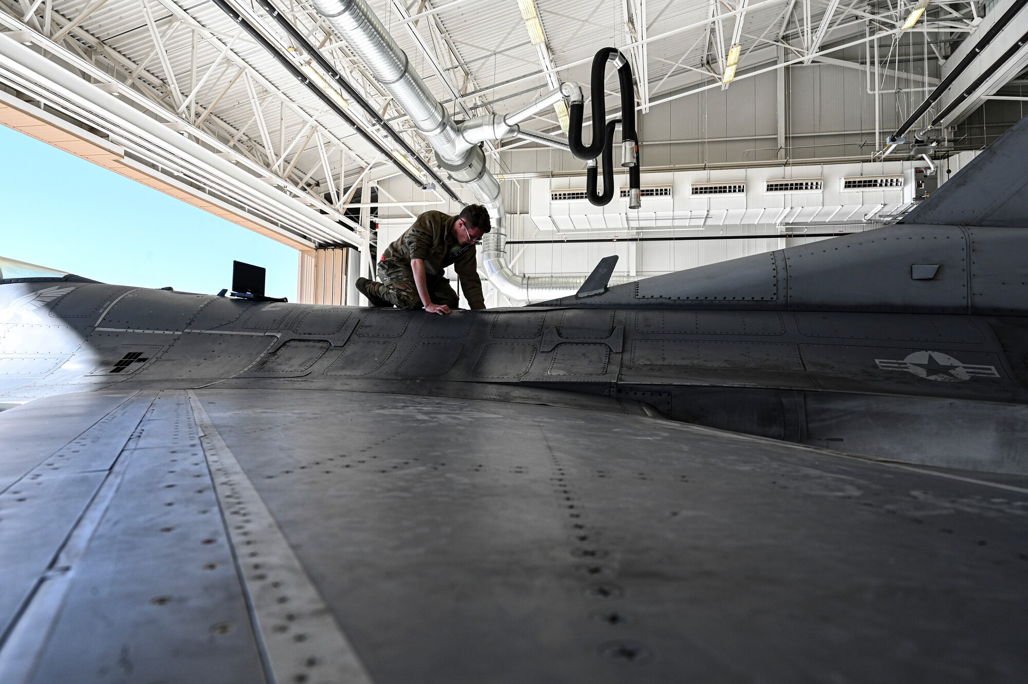 U.S. Air Force Senior Airman William Hunter, 49th Component Maintenance Squadron fuels journeyman, checks a valve on top of an F-16 Viper at Holloman Air Force Base, New Mexico, Feb. 8, 2023. The 49th CMS fuels shop is in charge of maintaining and supplying anything fuel-related to all F-16 Vipers on base. (U.S. Air Force photo by Airman 1st Class Isaiah Pedrazzini)