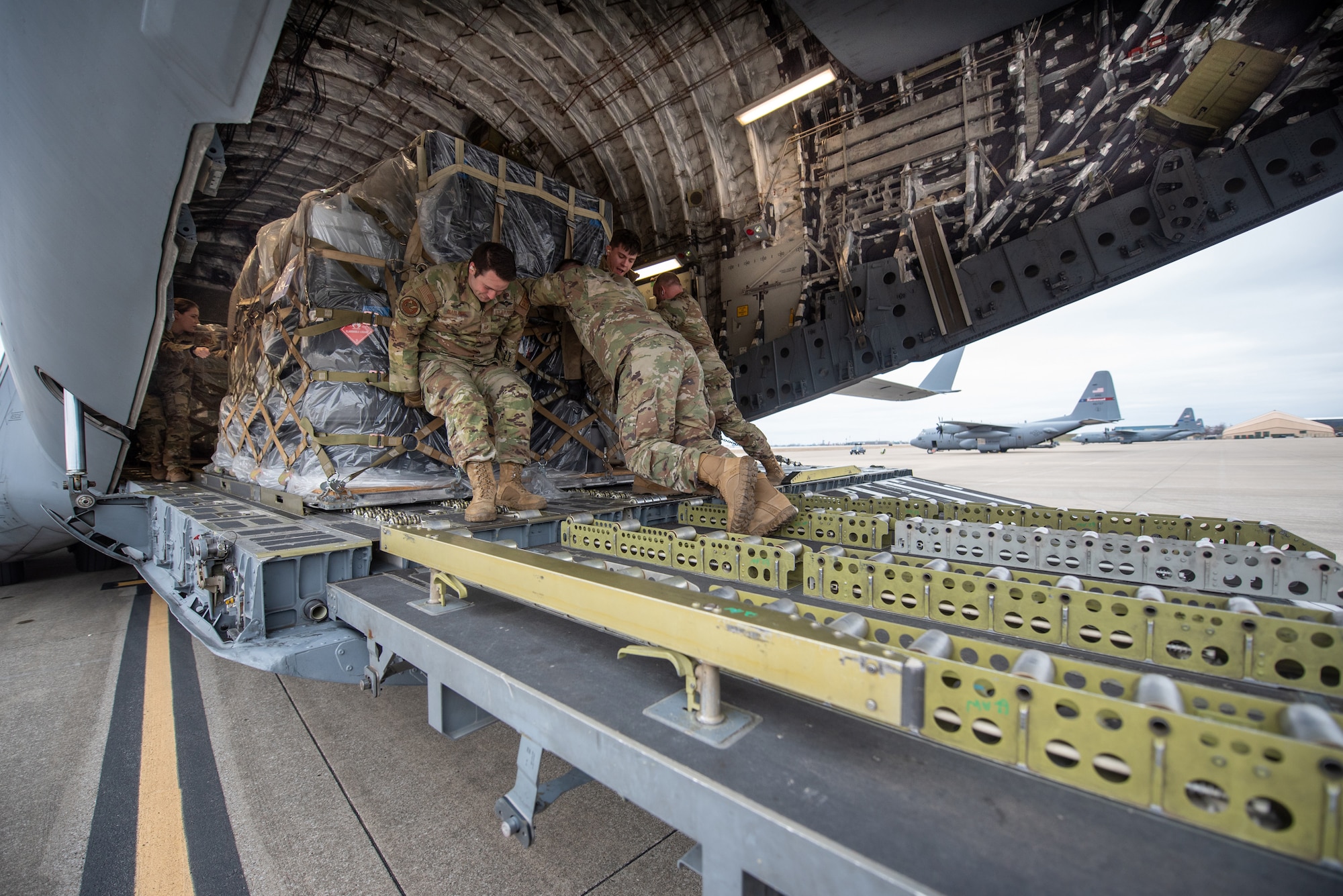 Members of the 123rd Logistics Readiness Squadron load a pallet of cargo onto a North Carolina Air National Guard C-17 Globemaster III at the Kentucky Air National Guard Base in Louisville, Ky., Feb. 10, 2023. The gear was transported to the Northern Mariana Islands for Cope North, a multinational exercise designed to enhance combat readiness in the South Pacific.